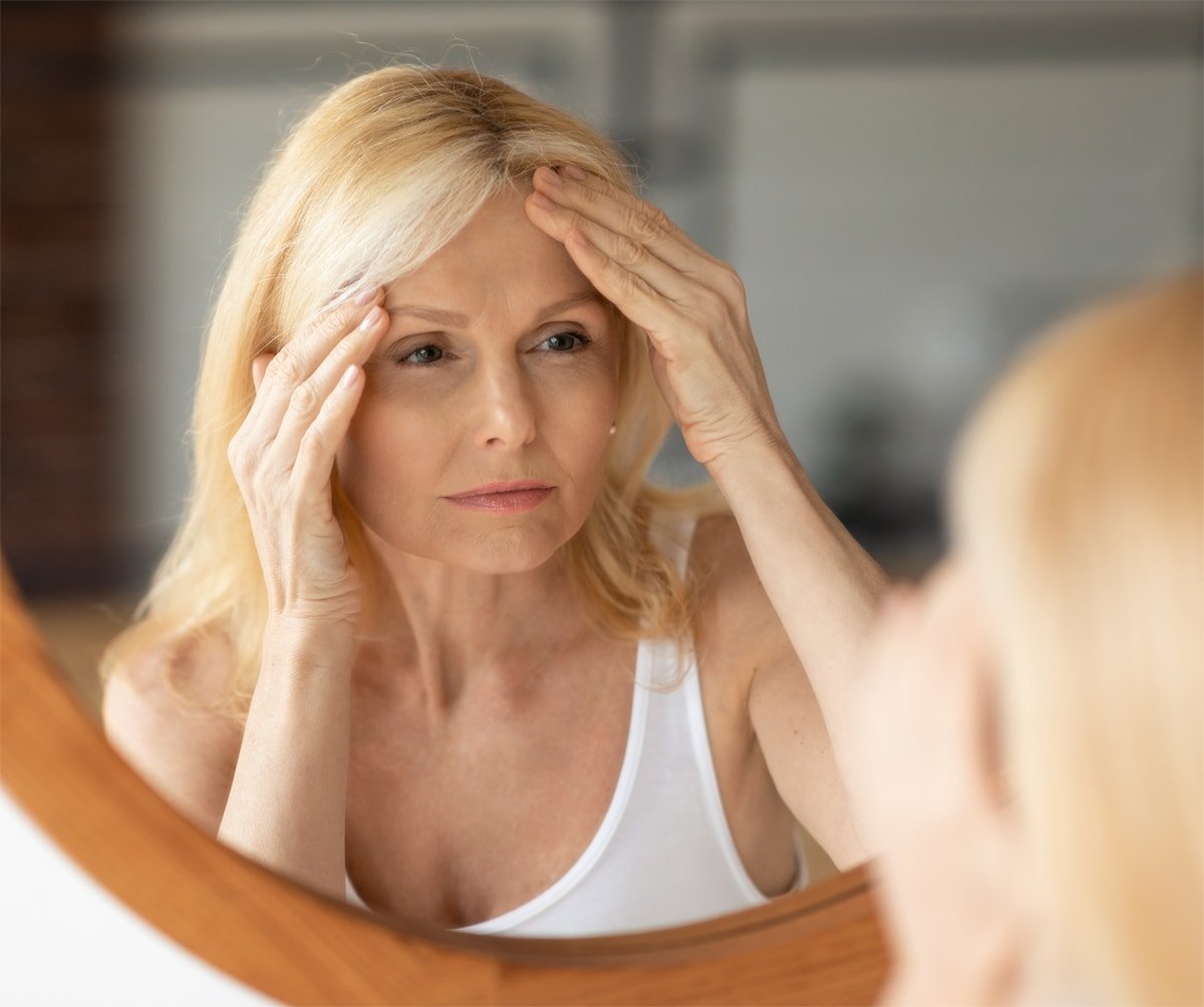 Brow lift candidate examining forehead wrinkles — Luxxery Boutique Waldorf MD